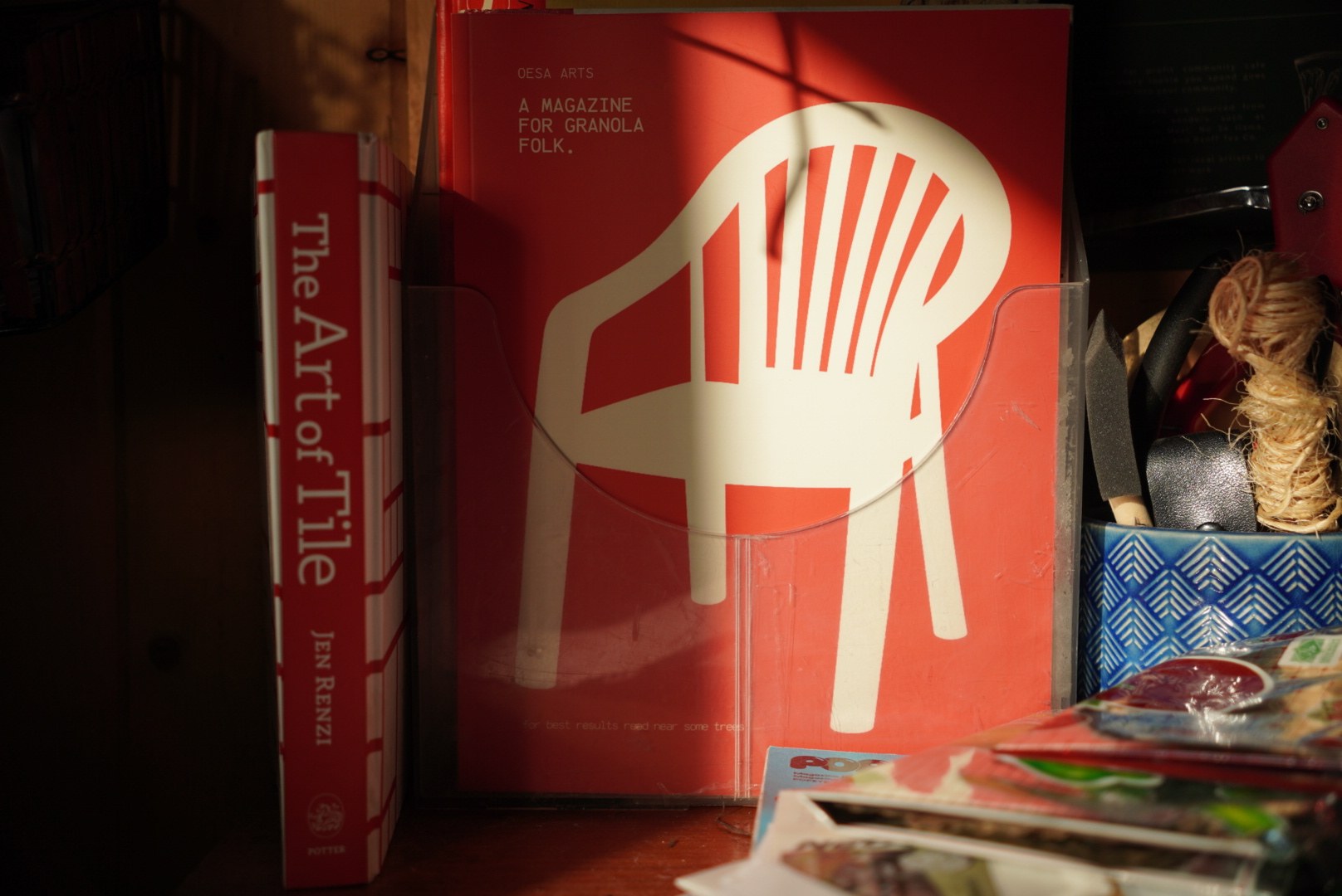 Oesa magazine copies with a red chair on the cover